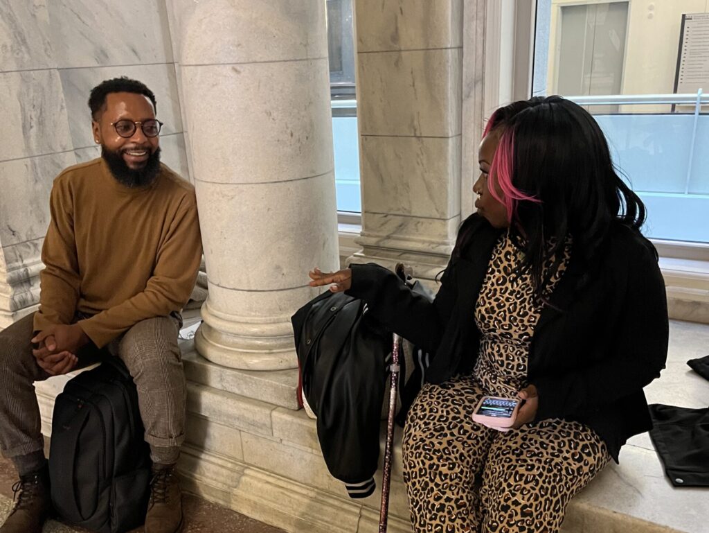 Photo of two advocates smiling and speaking to each other