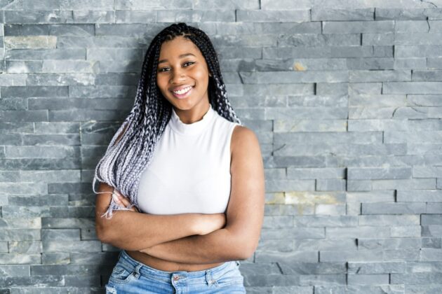 Stockphoto of teen girl against brick wall.