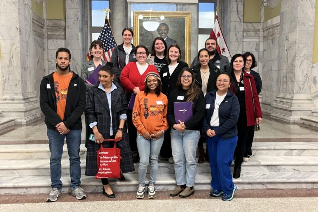 Group of advocates standing on the steps inside the John A. Wilson building.